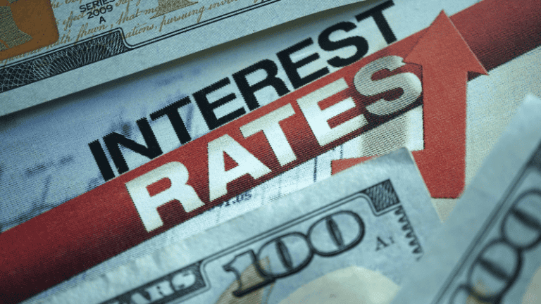 A close-up of currency with the words "Interest Rates" prominently displayed.