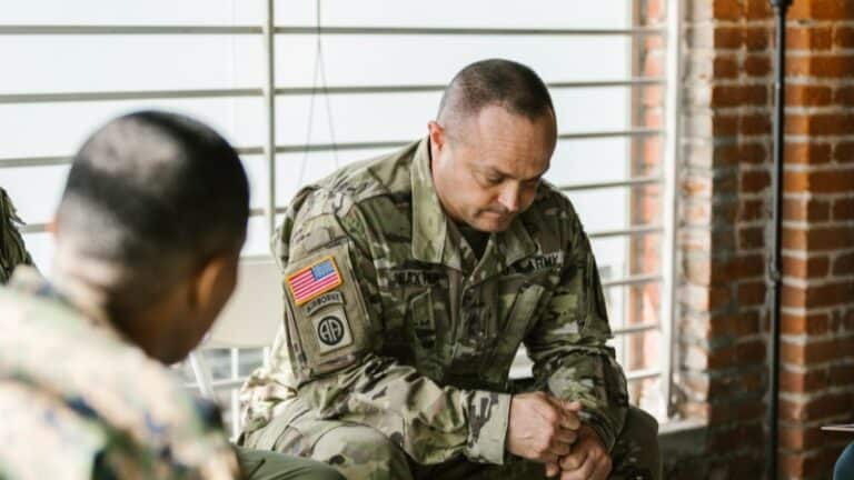 Soldier sitting, reflecting or in deep thought during meeting.