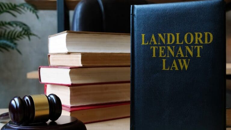 Landlord Tenant Law book with gavel and stacked books.