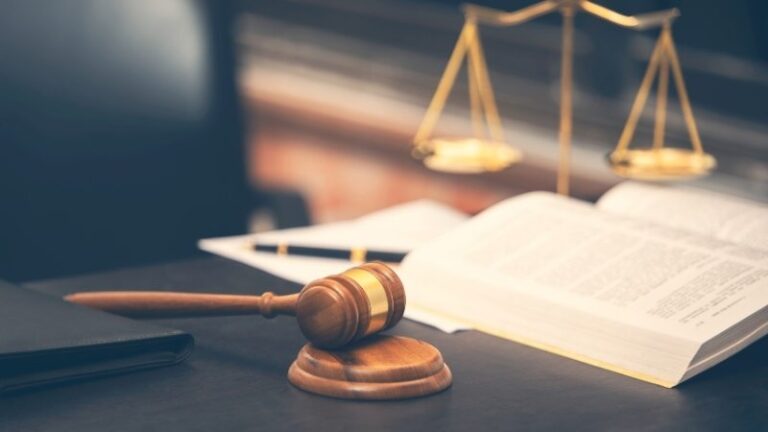 image of law book and gavel on wooden table