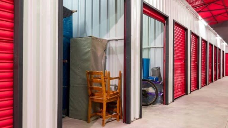 Furniture and items stored inside red self-storage units.