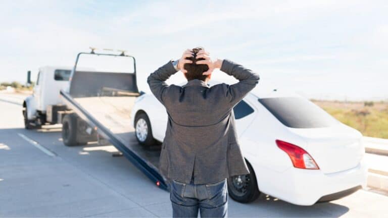Tow truck loading a vehicle during towing enforcement