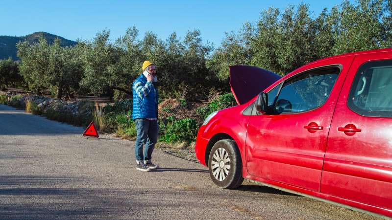 Vehicle With Open Hood On Roadside Representing Potential Abandonment