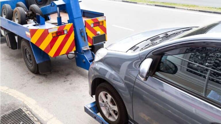 Tow Truck Removing Abandoned Vehicle From Roadside As Part Of Illinois Legal Process