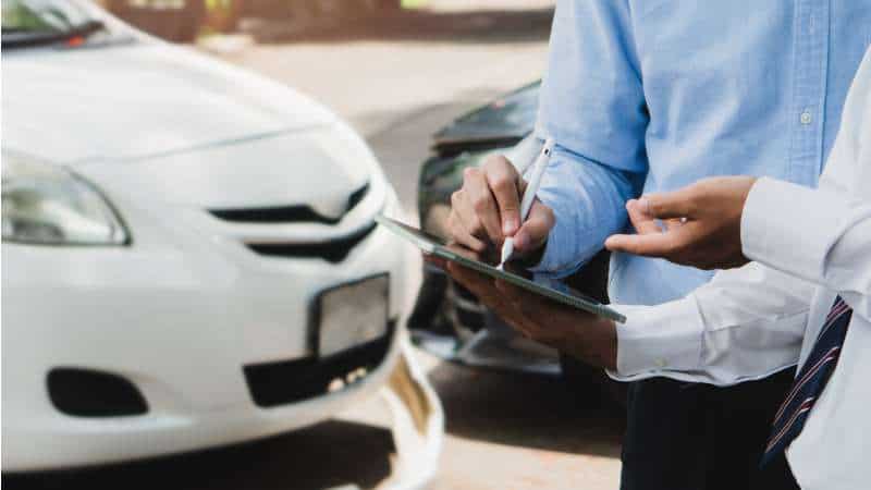 Individuals Completing Vehicle Inspection And Documentation For Title Process In Illinois