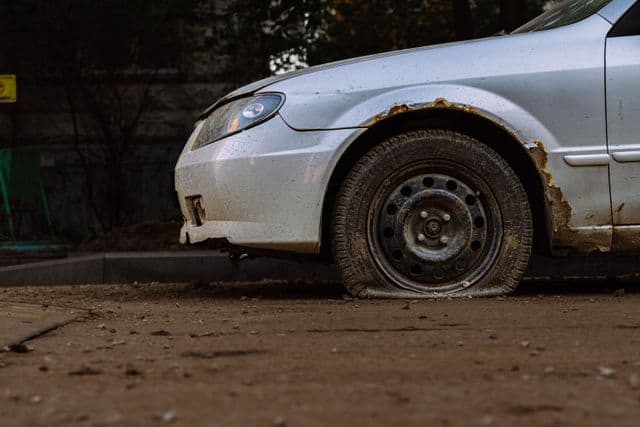 car with flat tire on the road